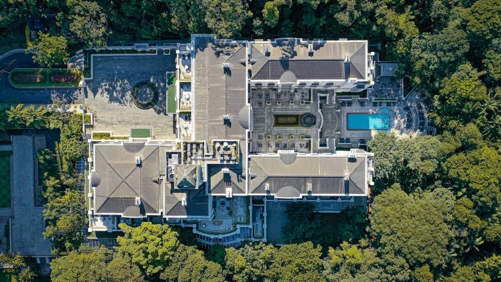 luxury villa with swimming pool surrounded by trees